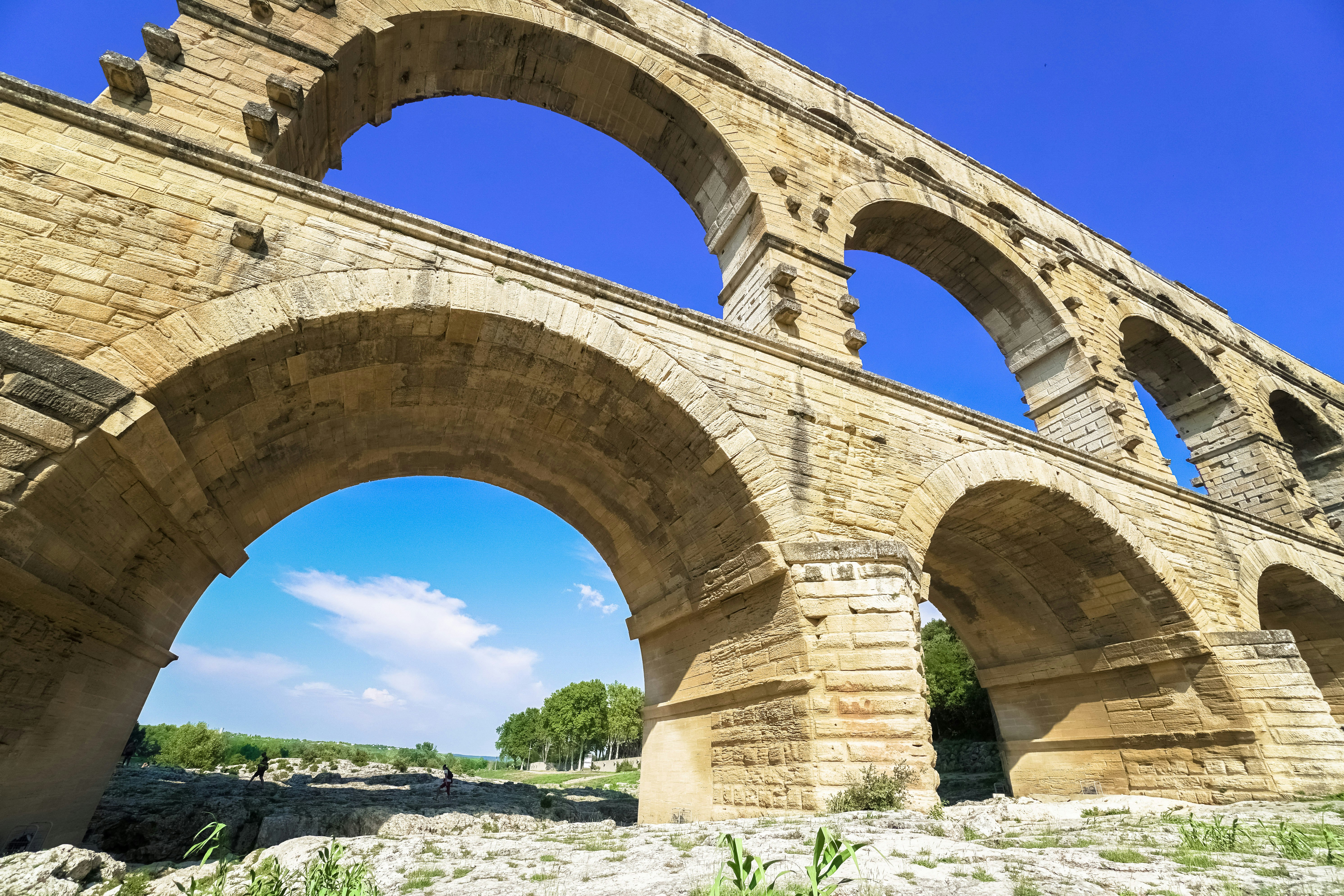 brown concrete arch bridge over river during daytime